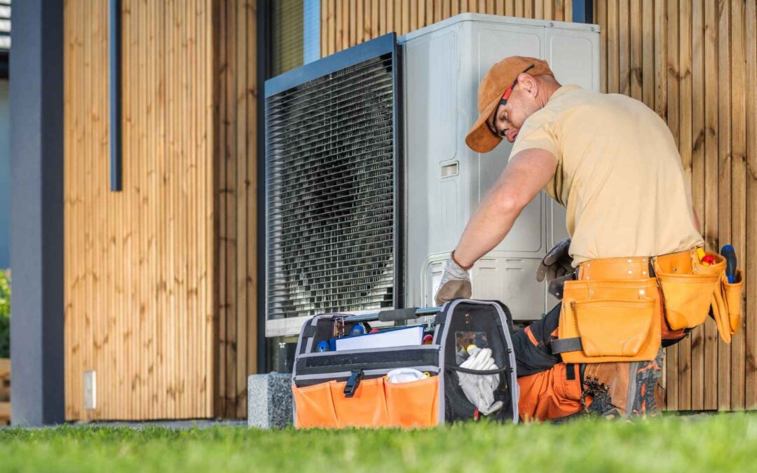 hvac technician fixing heat pump on a house