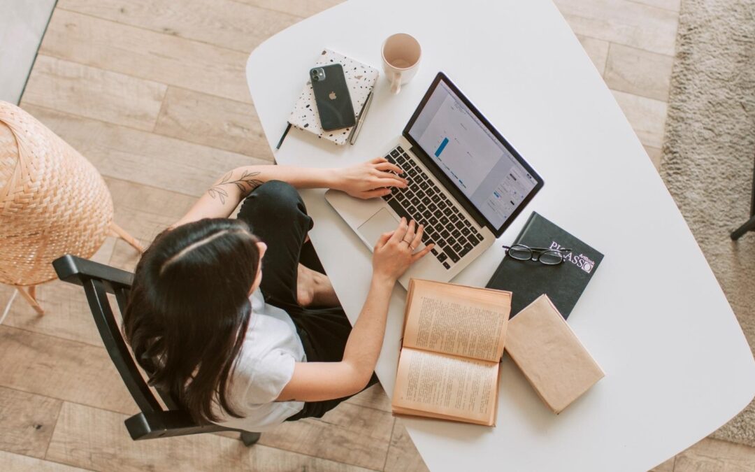 michigan seo services woman working on laptop at desk in office